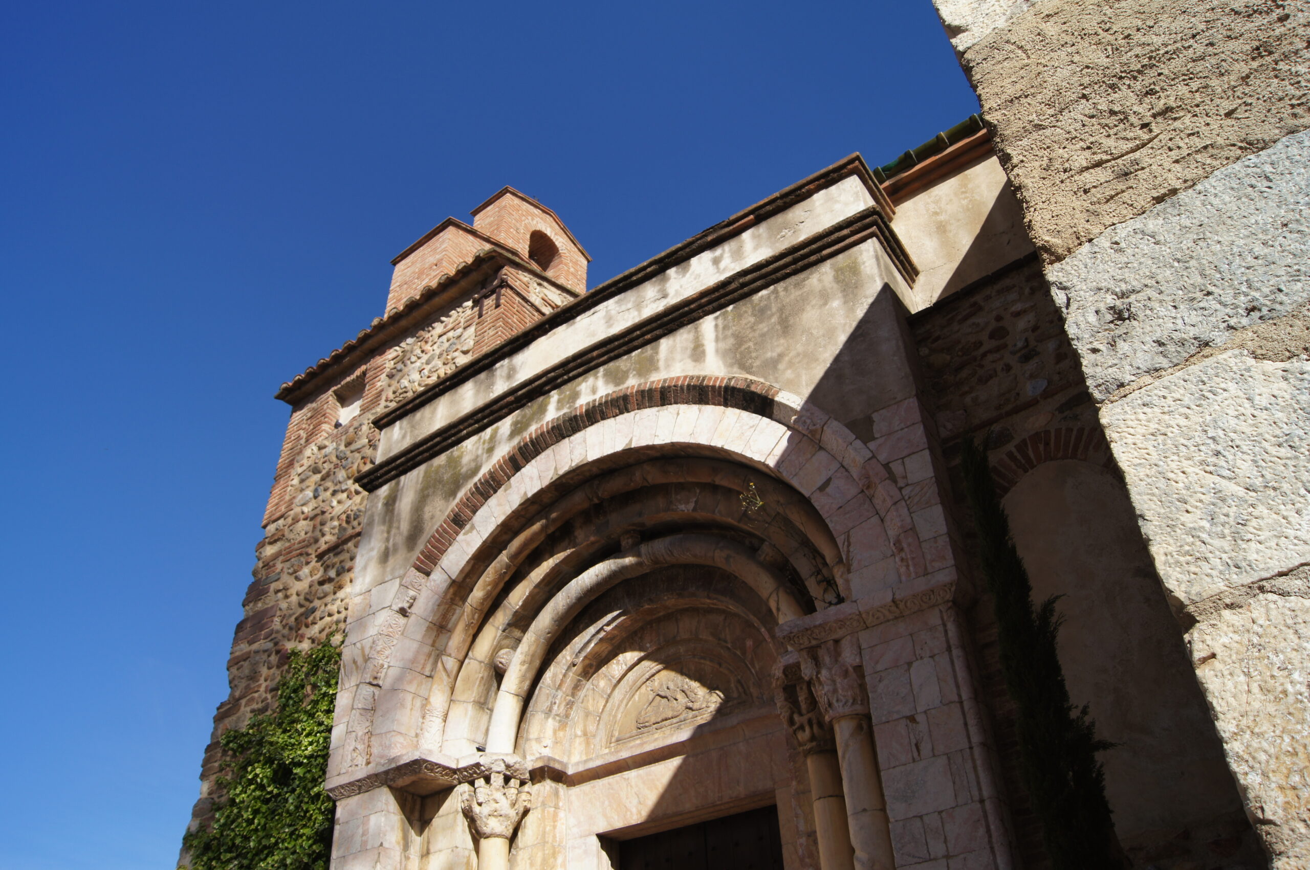 Le portail sculpté et le clocher de l’église Sainte-Marie de Toulouges